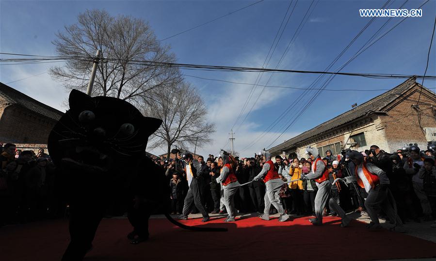 Folk artists wearing mouse costumes perform during a 'mouse marriage' shehuo show in Jiacun Village of Lucheng, north China's Shanxi Province, Feb. 17, 2016.