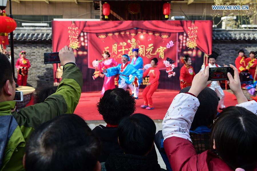 People watch a performance of Huangmei Opera, a form of rural folk song and dance, in Hefei, capital of east China's Anhui Province, Feb. 18, 2016. 