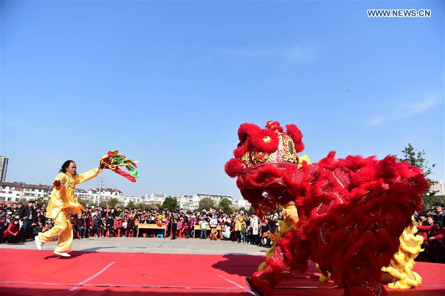 A lion dance is performed in Feixi County, east China's Anhui Province, Feb. 18, 2016. 