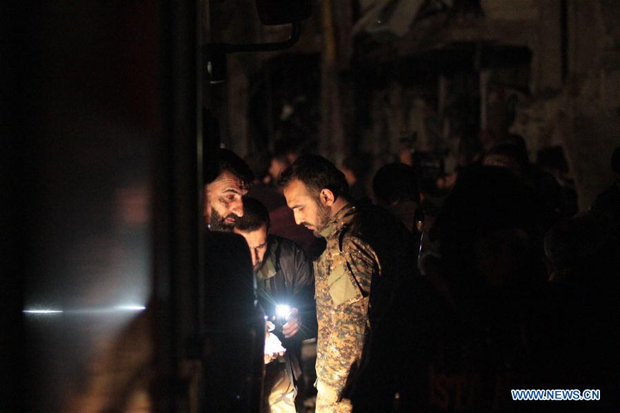 Syrians gather at the site of a series of attacks in the district of Sayyidah Zaynab, south of Damascus, Syria, Feb. 21, 2016. 