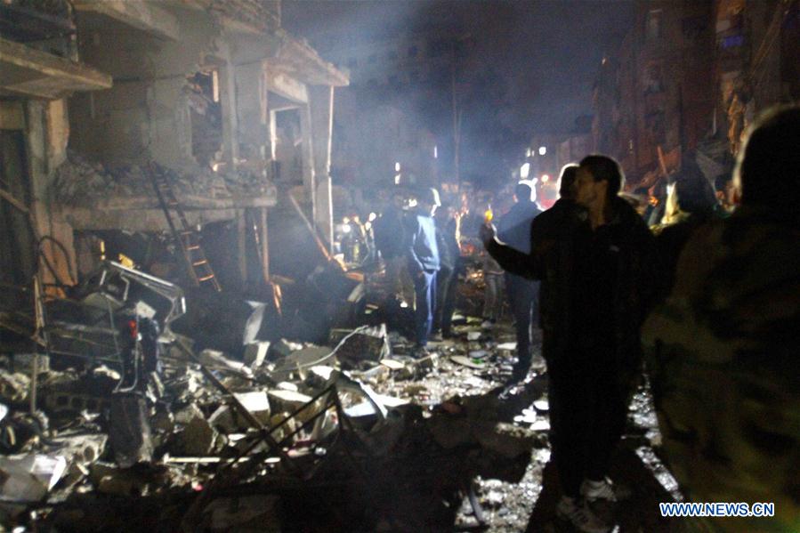 Syrians gather at the site of a series of attacks in the district of Sayyidah Zaynab, south of Damascus, Syria, Feb. 21, 2016. 