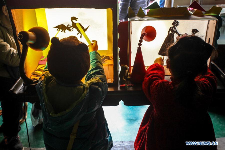 Children play Chinese shadow puppetry at Ziyuan Art Park in Tianjin, north China, Feb. 21, 2016. 