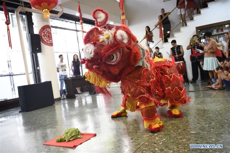 Participants perform Lion Dance during an event to end the celebration of the Chinese Lunar New Year at the ORT University of Uruguay in Montevideo, capital of Uruguay, on Feb. 22, 2016. 