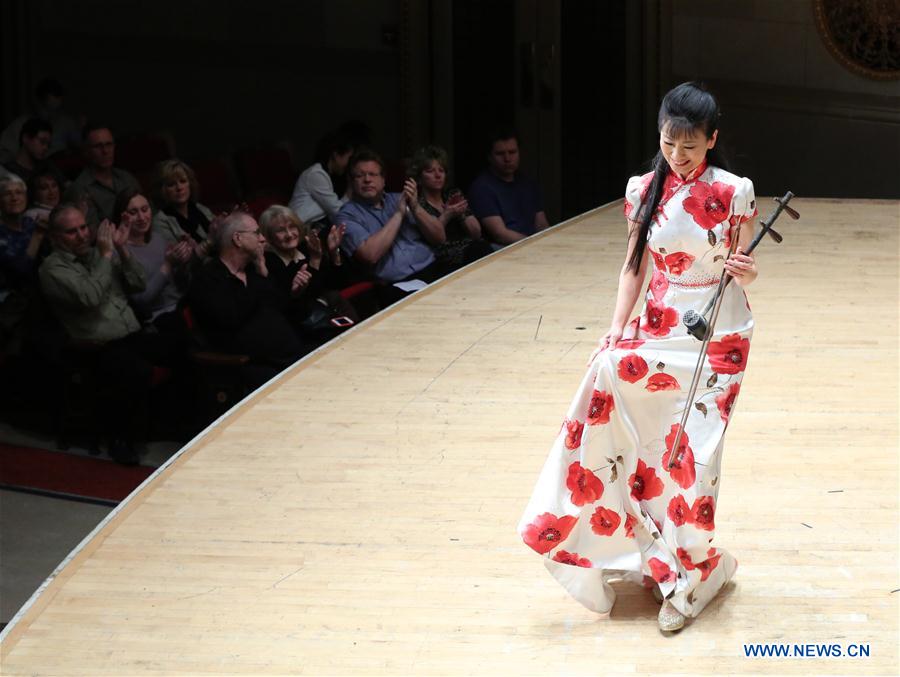 Banhu performer Jiang Kemei of China Radio Nationalities Orchestra reacts to the audience after performing at the Orchestra Hall in Detroit, the United States, Feb. 22, 2016.