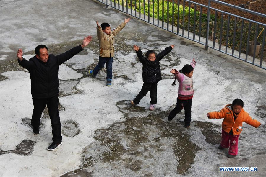 Primary school teacher Tao Chaolei, 52, exercises with his four students, including one in grade three and three pre-school kids, at the start of the new term at Sujiacun Village of Wushan County in southwest China's Chongqing, Feb. 24, 2016.