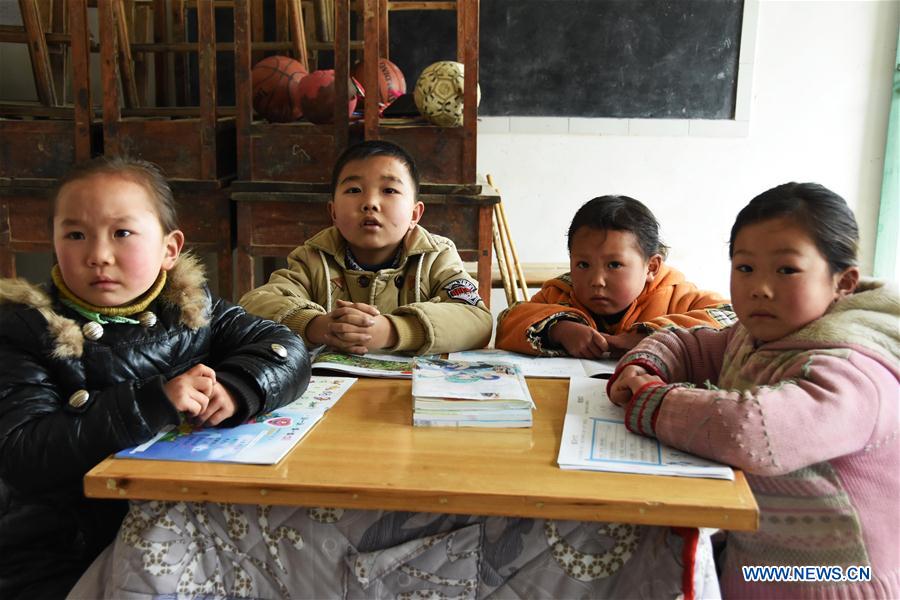 Students attend a class in a primary school at Sujiacun Village of Wushan County in southwest China's Chongqing, Feb. 24, 2016. 