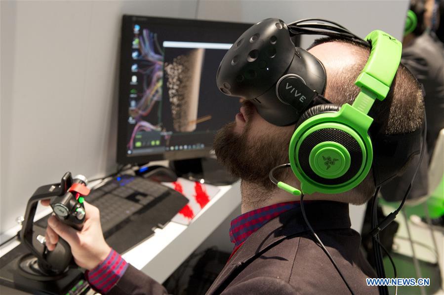 An attendee tries the HTC virtual experience VIVE at the Mobile World Congress in Barcelona, Spain, Feb. 23, 2016. 