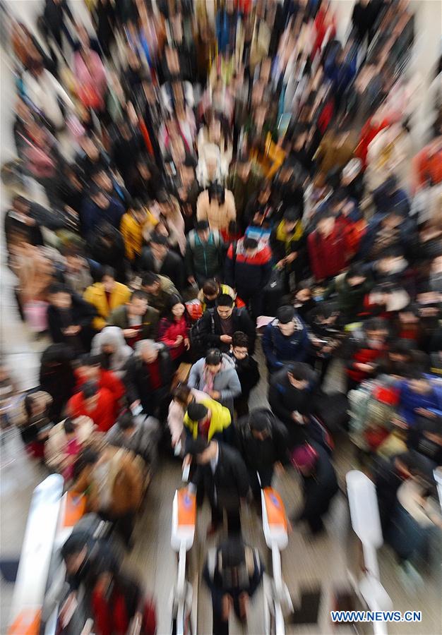 Passengers have tickets checked and get into the railway station in Shijiazhuang, capital of north China's Hebei Province, Feb. 24, 2016. 