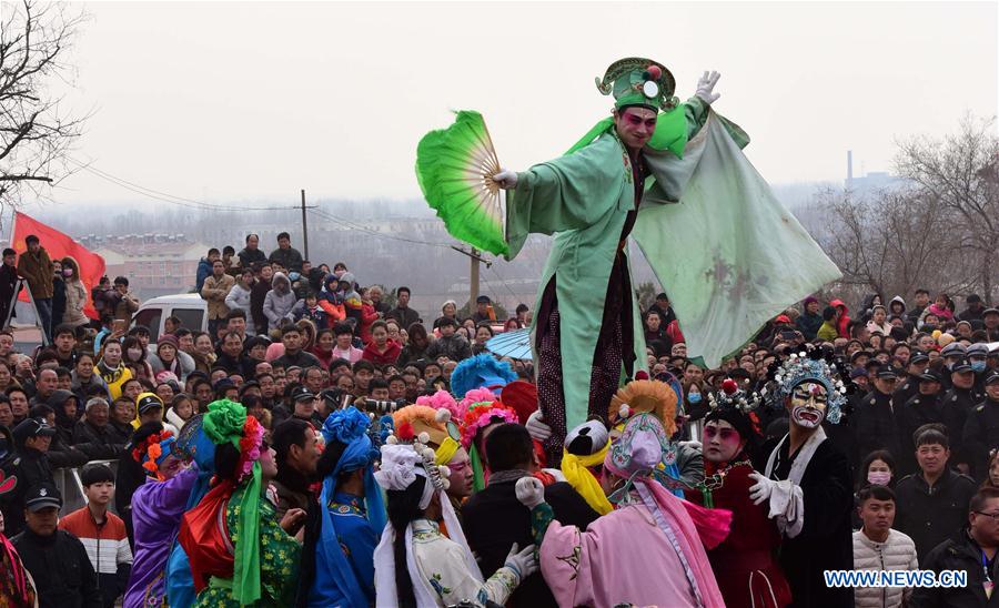 Rural folk performers dressed in traditional costume perform to celebrate the Chinese lunar New Year at a temple fair in Xunxian County of Hebi City, central China's Henan Province, Feb. 23, 2016.