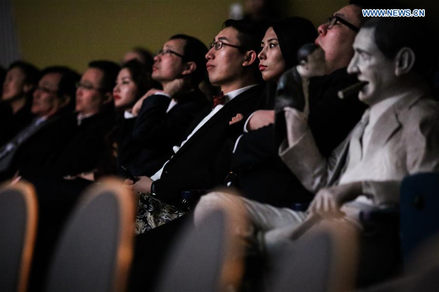 Guests watch a movie during the opening ceremony of the 1st Berlin Chinese Film Festival at the Kino Babylon in Berlin, Germany, on Feb. 24, 2016.