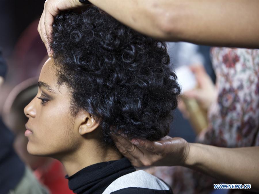  A model has her hair styled at backstage before the Anteprima show during Milan Fashion Week Fall/Winter 2016/17 in Milan, Italy, Feb. 25, 2016. 