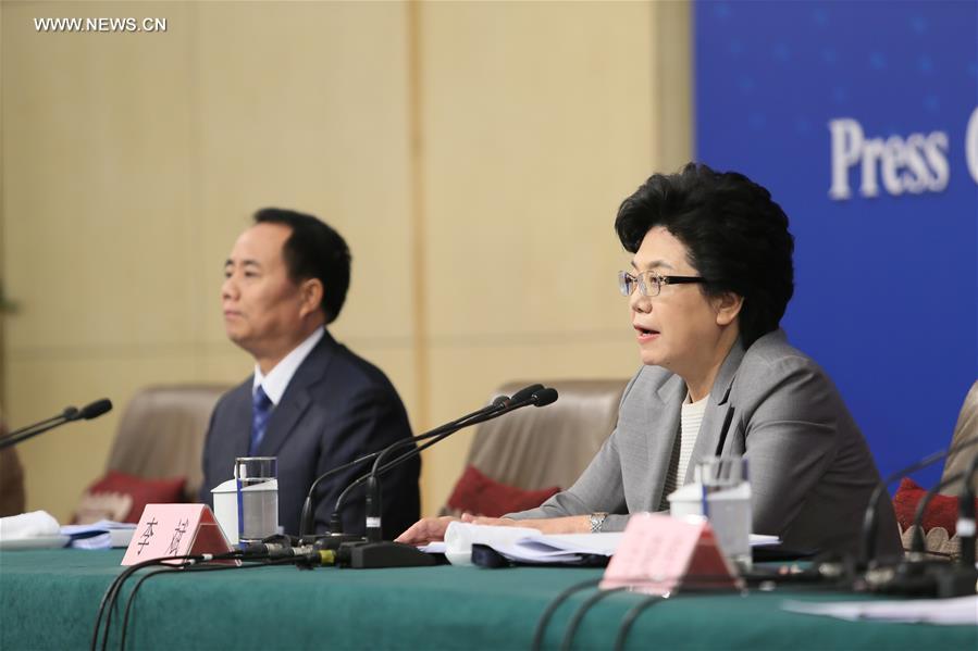 Li Bin (R), minister in charge of the National Health and Family Planning Commission, answers questions at a press conference on China's two-child policy on the sidelines of the fourth session of China's 12th National People's Congress in Beijing, capital of China, March 8, 2016.