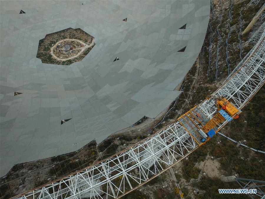 Workers install reflector panels of the single-aperture spherical telescope 'FAST' in Pingtang County, southwest China's Guizhou Province, March 9, 2016.