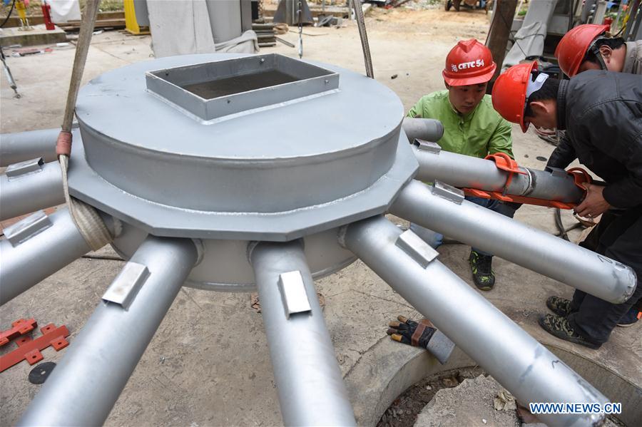 Workers assemble a part of the single-aperture spherical telescope 'FAST' in Pingtang County, southwest China's Guizhou Province, March 9, 2016.