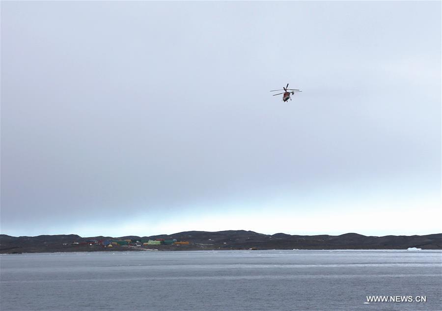 A helicopter of Chinese icebreaker Xuelong, or Snow Dragon, flies to the Australia's Davis research station to help carry goods and materials left by a stranded Australian icebreaker in Antarctica March 8, 2016.