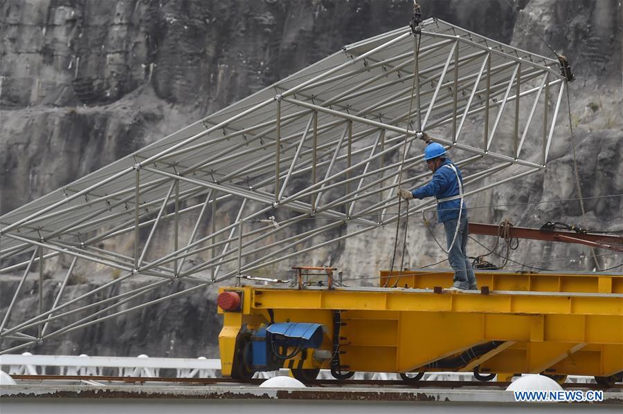 A worker installs reflector panels of the single-aperture spherical telescope 'FAST' in Pingtang County, southwest China's Guizhou Province, March 9, 2016. 