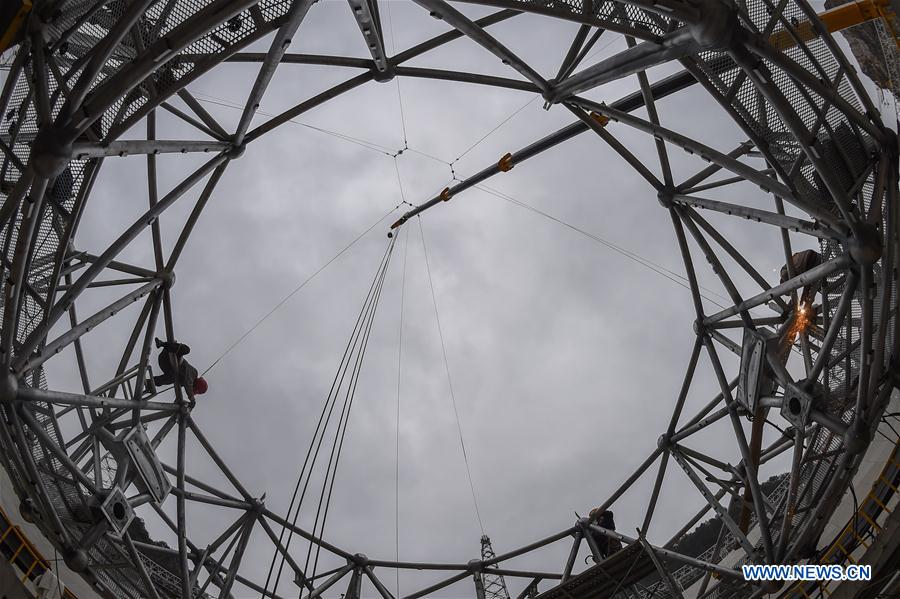 Workers assemble the single-aperture spherical telescope 'FAST' in Pingtang County, southwest China's Guizhou Province, March 9, 2016.