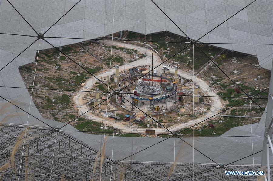 Workers assemble the single-aperture spherical telescope 'FAST' in Pingtang County, southwest China's Guizhou Province, March 9, 2016. 