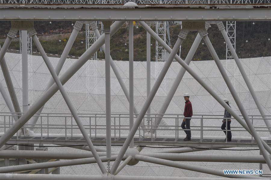 Workers walk on the ring beam of the single-aperture spherical telescope 'FAST' in Pingtang County, southwest China's Guizhou Province, March 9, 2016.