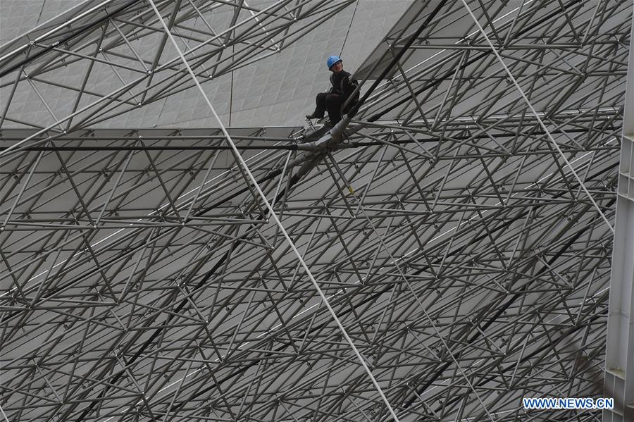 A worker installs reflector panels of the single-aperture spherical telescope 'FAST' in Pingtang County, southwest China's Guizhou Province, March 9, 2016.