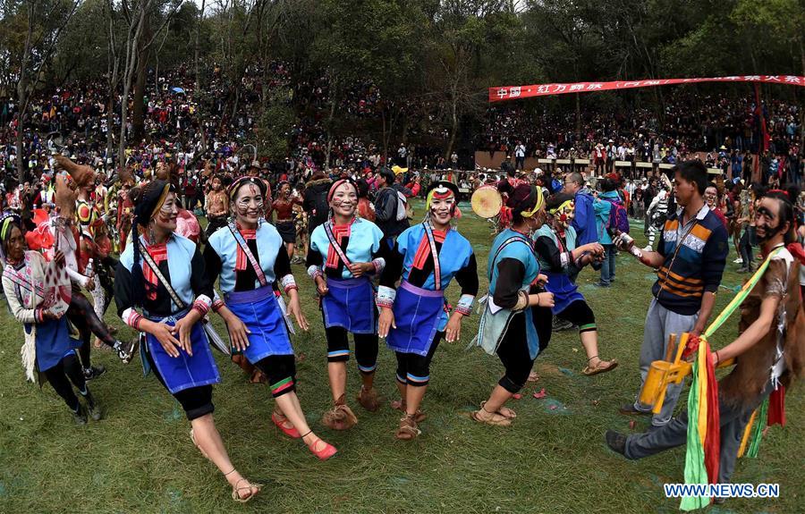 People of Yi ethnic group dance and sing during the annual fire worshipping festival, which falls on the third day of the second month in the Chinese lunar calendar, in Hongwan Village of Xiyi Township in Mile City, southwest China's Yunnan Province, March 11, 2016. 