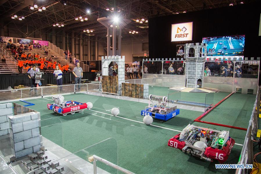 Team members of 'FLYBOTS' from Brooklyn's Paul Robeson High School work on their robot at the 2016 FIRST Robotics Competition New York Regional in Jacob Javits Convention Center in New York City, the United States, March 11, 2016.