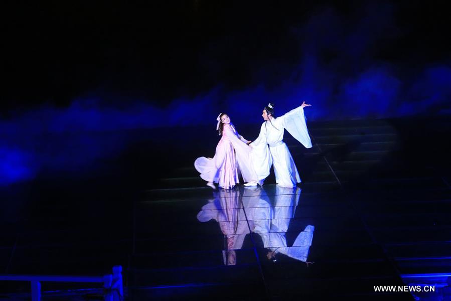 An actor paddles a boat on water during an on-water performance reproducing the prosperity of capital city Kaifeng (historically known as Daliang, Bianliang, Bianjing, Dongjing) of Northern Song Dynasty (960-1127 AD) in Kaifeng, Central China's Henan Province, March 11, 2016