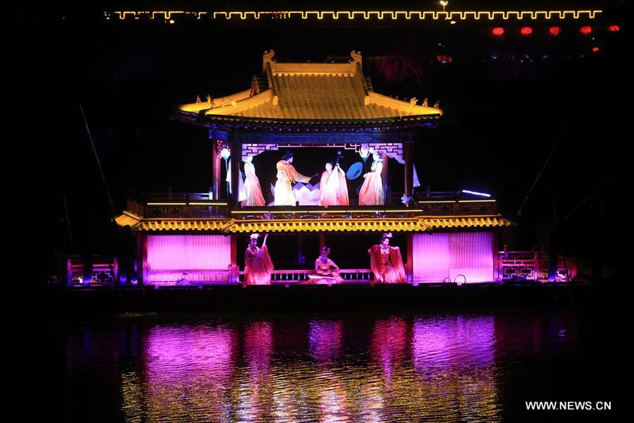 An actor paddles a boat on water during an on-water performance reproducing the prosperity of capital city Kaifeng (historically known as Daliang, Bianliang, Bianjing, Dongjing) of Northern Song Dynasty (960-1127 AD) in Kaifeng, Central China's Henan Province, March 11, 2016