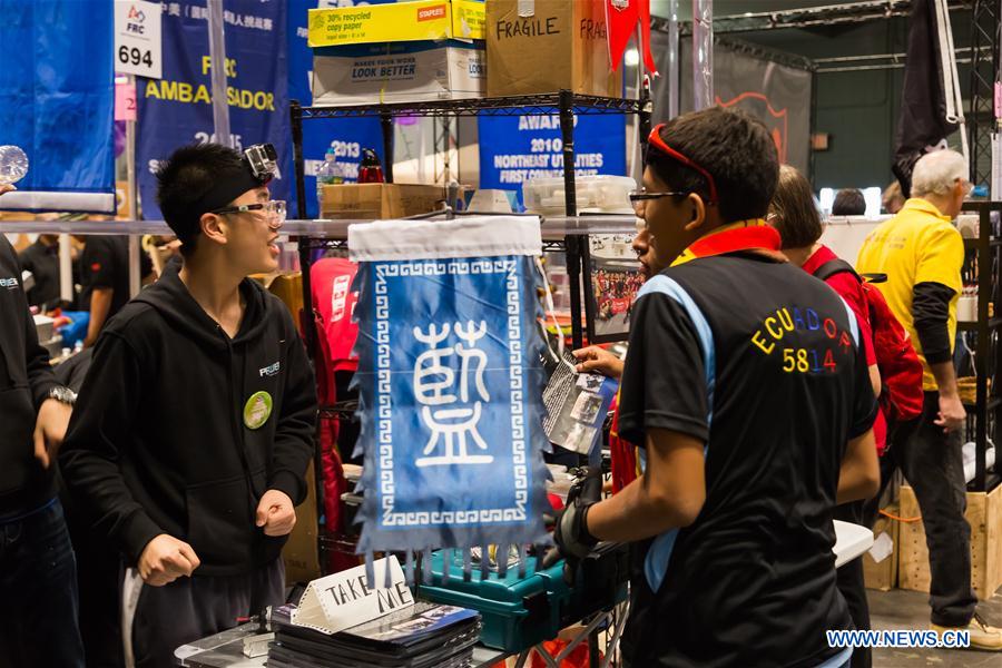 Team members of 'FLYBOTS' from Brooklyn's Paul Robeson High School work on their robot at the 2016 FIRST Robotics Competition New York Regional in Jacob Javits Convention Center in New York City, the United States, March 11, 2016.