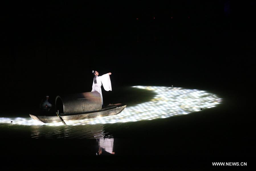 An actor paddles a boat on water during an on-water performance reproducing the prosperity of capital city Kaifeng (historically known as Daliang, Bianliang, Bianjing, Dongjing) of Northern Song Dynasty (960-1127 AD) in Kaifeng, Central China's Henan Province, March 11, 2016