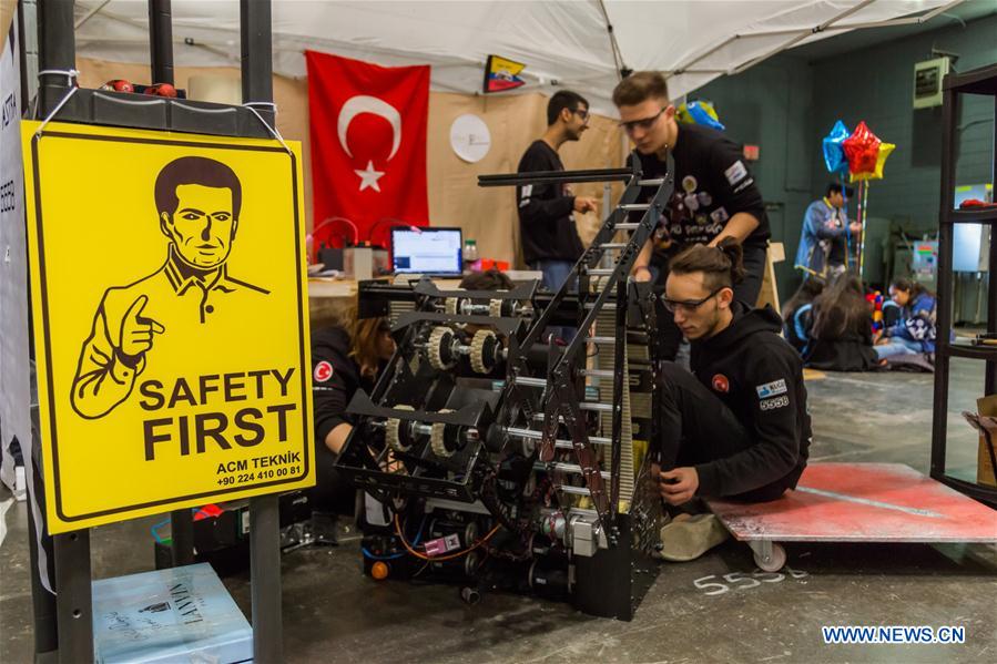 Team members of 'FLYBOTS' from Brooklyn's Paul Robeson High School work on their robot at the 2016 FIRST Robotics Competition New York Regional in Jacob Javits Convention Center in New York City, the United States, March 11, 2016.