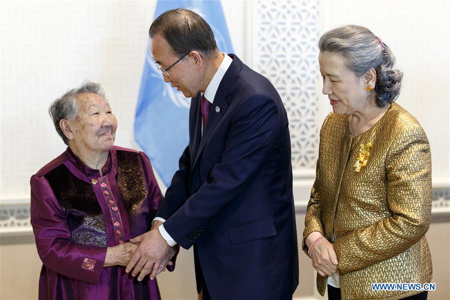 United Nations Secretary-General Ban Ki-moon (R) and his wife Yoo Soon-taek (L) pose for a photo with Gil Won-ok, one of the victims who were drafted by Japan as so-called 'comfort women' during the Second World War, at the UN headquarters in New York, March 11, 2016.