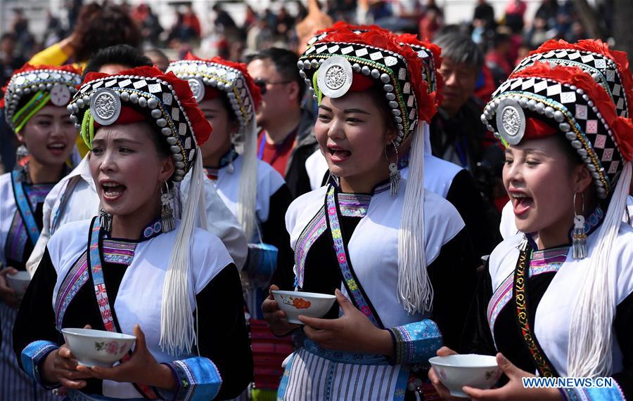 People of Yi ethnic group sing a toasting song during the annual fire worshipping festival, which falls on the third day of the second month in the Chinese lunar calendar, in Hongwan Village of Xiyi Township in Mile City, southwest China's Yunnan Province, March 11, 2016. 