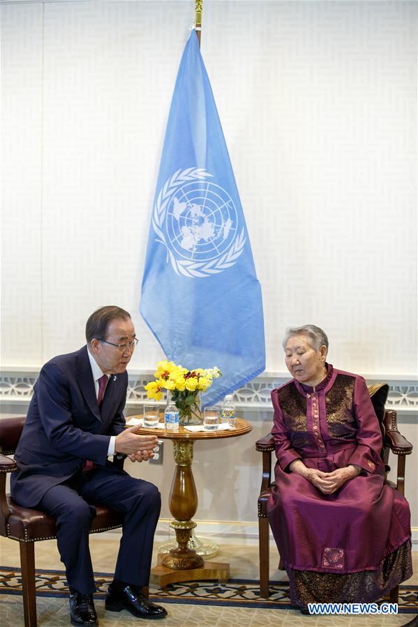 United Nations Secretary-General Ban Ki-moon (R) and his wife Yoo Soon-taek (L) pose for a photo with Gil Won-ok, one of the victims who were drafted by Japan as so-called 'comfort women' during the Second World War, at the UN headquarters in New York, March 11, 2016.