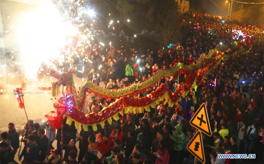 People perform dragon dance during Huodeng Festival in Jiepai Town, Hengyang County of central China's Hunan Province, March 15, 2016.