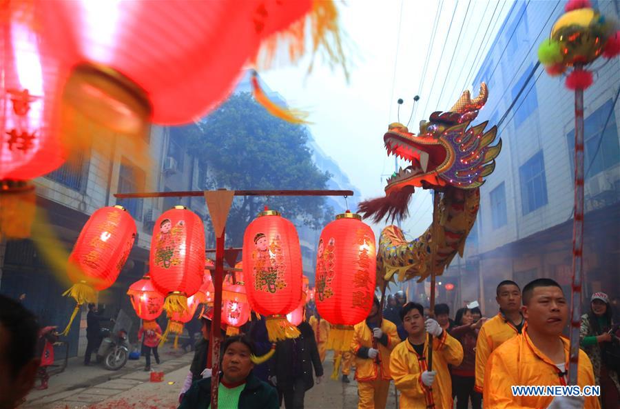 People perform dragon dance during Huodeng Festival in Jiepai Town, Hengyang County of central China's Hunan Province, March 15, 2016.