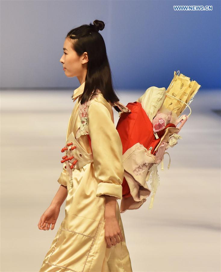 A model presents a creation at a special show for creative women's fashion in Beijing, capital of China, March 15, 2016. 