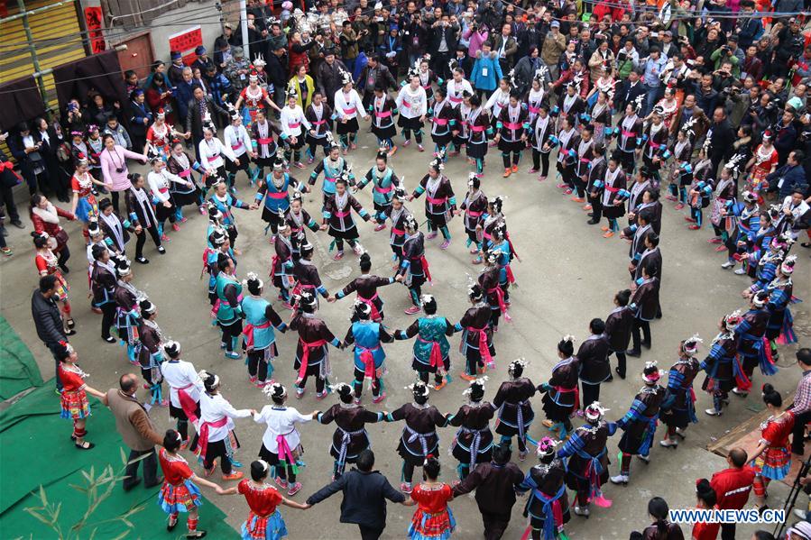  People of Dong ethnic group sing local songs to celebrate a festival blessing for good fortune in Long'e Town of Qiandongnan Miao and Dong Autonomous Prefecture, southwest China's Guizhou Province, March 16, 2016. 