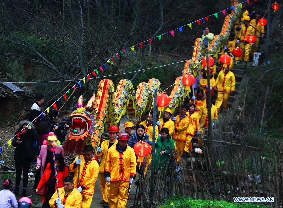 People perform dragon dance during Huodeng Festival in Jiepai Town, Hengyang County of central China's Hunan Province, March 15, 2016.