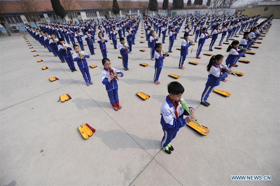 Pupils of Foyelai Primary School perform Hulusi, a gourd-shaped traditional wind instrument, in Xinglong County of Chengde City, north China's Hebei Province, March 16, 2016. 