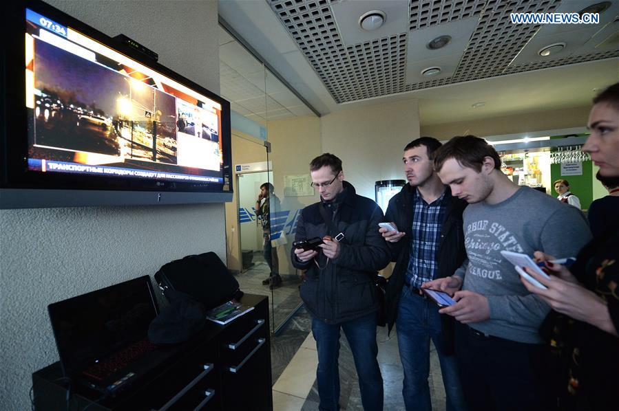 People watch news broadcast at the airport of Rostov-on-Don in southwestern Russia, where the Flydubai Flight 981 crashed, March 19, 2016. 