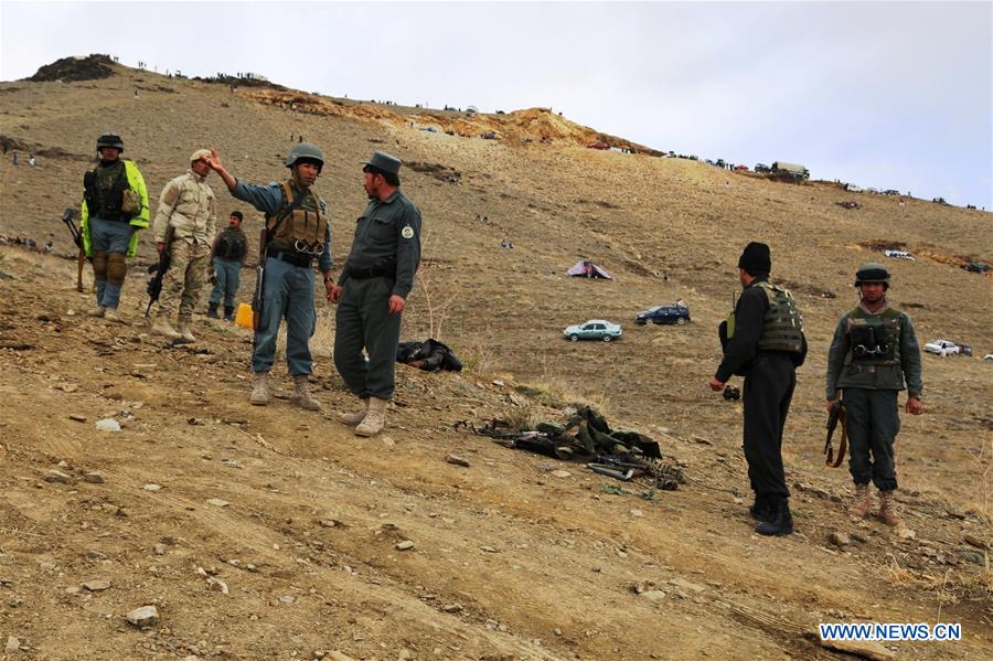 Afghan policemen inspect the site of a blast in Ghazni province, east Afghanistan, March 20, 2016.
