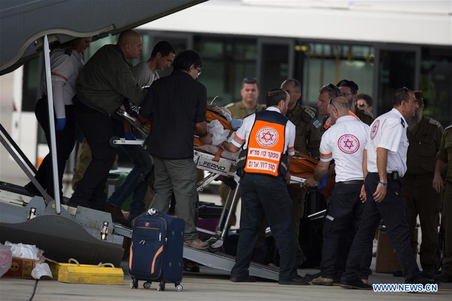 Emergency personnel transfer injured Israeli in the Istanbul suicide bomb attack upon their arrival at the Ben Gurion airport near Tel Aviv, Israel, March 20, 2016.