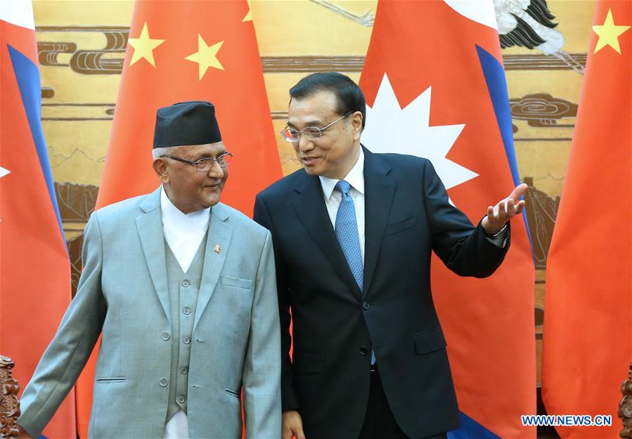 Chinese Premier Li Keqiang (R) talks with Nepalese Prime Minister K. P. Oli during the signing ceremony of bilateral cooperation documents in Beijing, capital of China, March 21, 2016.