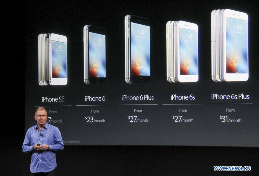 Visitors take photos of the new iPhones, named iPhone SE, during an event to announce new products at Apple's headquarters in Cupertino, California, the United States, March 21, 2016. 