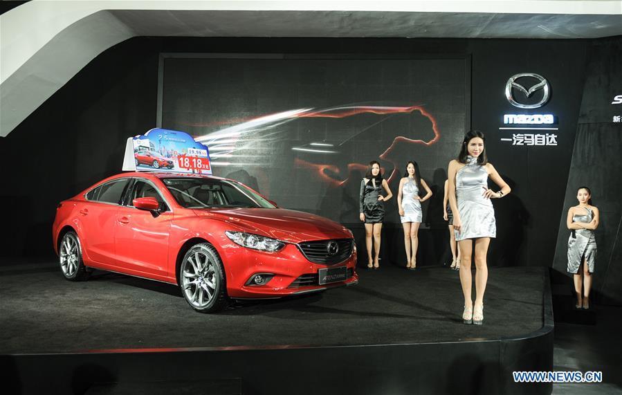 A new car of Madza is shown during the 11th Harbin spring auto show in Harbin, capital of northeast China's Heilongjiang Province, March 22, 2016. 