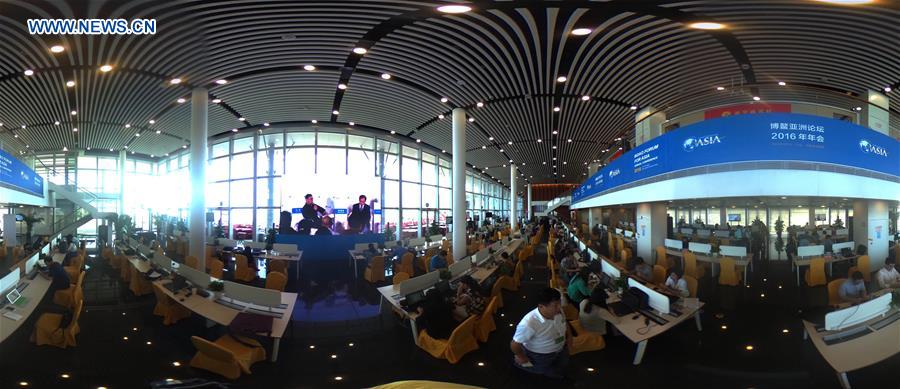 Panoramic photo shows journalists working in the press center in the annual Boao Forum for Asia (BFA) in Boao, south China's Hainan Province, March 22, 2016.