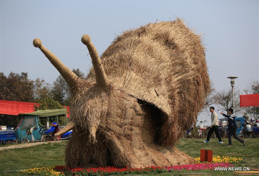 Photo taken on March 26, 2016 shows a straw-made mantis during a tourism festival in Nanjing, capital of east China's Jiangsu Province.