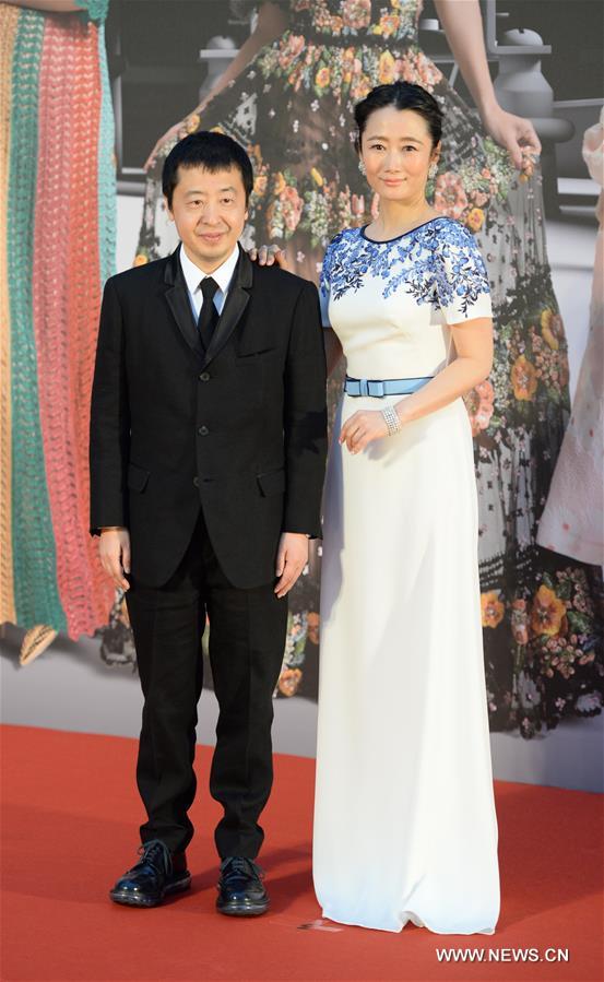 Director Jia Zhangke (L) and his wife Zhao Tao pose on the red carpet before the 35th Hong Kong Film Awards presentation ceremony in Hong Kong, south China, April 3, 2016