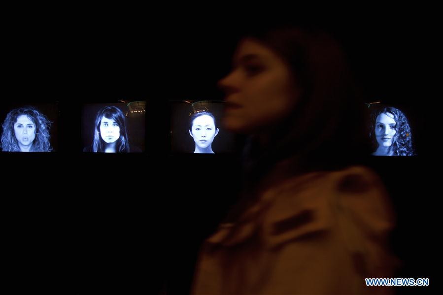 A visitor looks at an artwork 'Double Neon Elevator', part of the exhibition 'Doubt' in Milan, Italy, on April 6, 2016. 